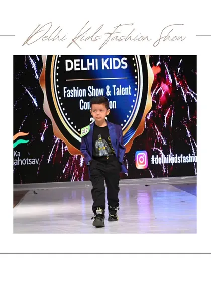 This young model owns the runway in a cool blue blazer and graphic tee. It's a perfect example of the "smart casual" style that many boys love to showcase.