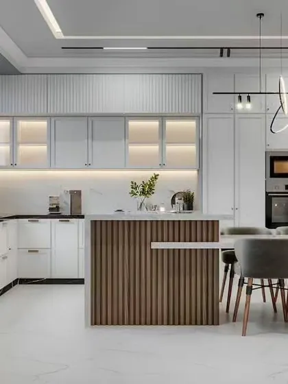 A sophisticated kitchen with a wood-paneled island that flows into a dining area. The frosted glass upper cabinets and modern lighting add to the elegant feel.