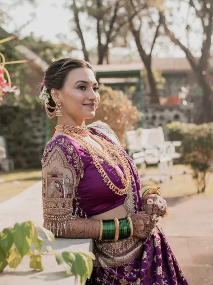 A sunlit portrait of the bride in her royal purple Nauvari.
