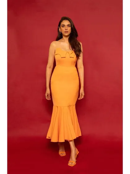 A pop of sunshine for Aditi Rao Hydari. This strapless orange mermaid dress by RSR is fun, flirty, and perfect for making a bright statement.