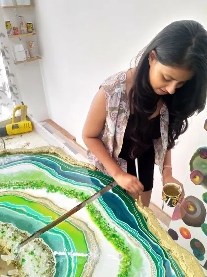 Here I am in my studio, adding the final gold touches to a large green geode piece. This meditative process is where the artwork truly comes to life for me.