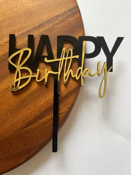 This black and gold layered acrylic topper offers a chic and sophisticated way to say "Happy Birthday."