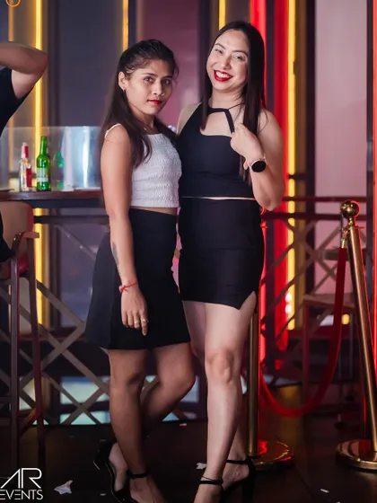 Two friends posing for a quick photo before hitting the dance floor.