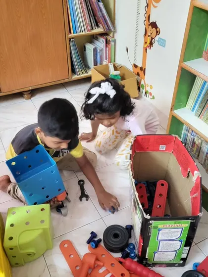 Siblings working together with our construction toy set. It's wonderful to see them collaborating, sharing ideas, and building something new.