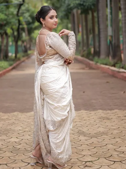 This pose shows the beautiful fall of the saree and the stylish heels that can be paired with this traditional outfit.