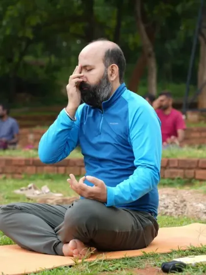 A participant practices Nadi Shodhana pranayama, or alternate nostril breathing. This is a core technique we teach in our Happiness Program to balance the mind, calm the nervous system, and improve focus.