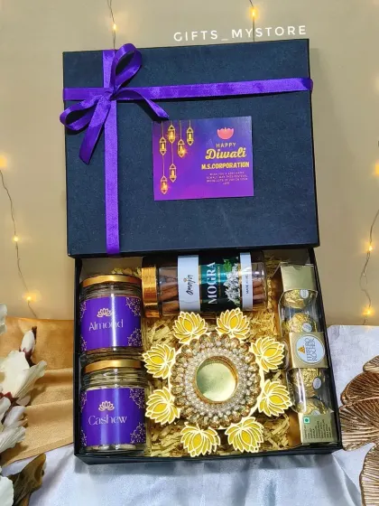 Our premium black corporate hamper, tied with a custom-branded ribbon for M.S. Corporation. It’s filled with dry fruits, incense, chocolates, and a diya.