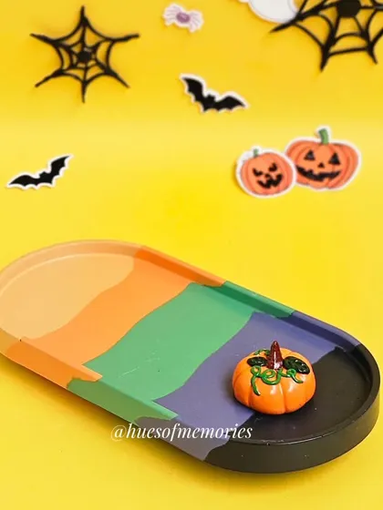The Halloween palette oval tray with a tiny pumpkin. The bright colors make it a fun and eye-catching piece.