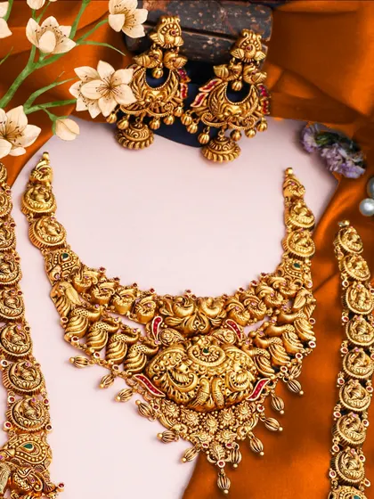 A festive statement set perfect for bridal wear. This image showcases a heavy temple necklace with matching bracelets, crafted with intricate details and designed to be a showstopper.