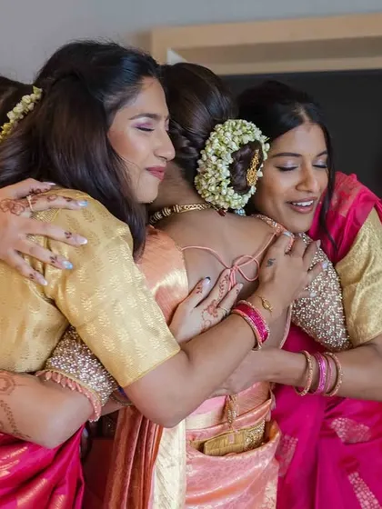 A close-up of the emotional group hug, showing the genuine affection and bond between the bride and her friends.