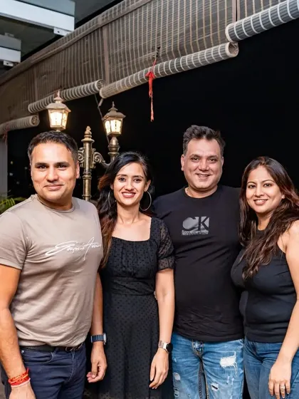 A group of friends enjoying the cool night air on the rooftop. It's a great space for larger groups to gather and socialize.