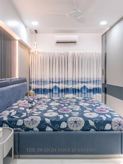 This shot highlights the overall design of the bedroom, with its plush upholstered bed and smart, multifunctional furniture. It's a space crafted for both comfort and elegance.