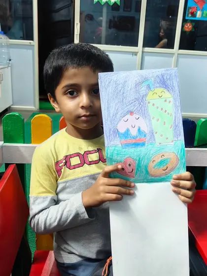 This student drew a collection of happy-faced desserts, including a cupcake, a donut, and a smoothie.