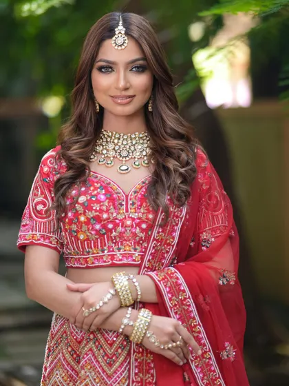 This bride is radiant in a red lehenga with multi-color floral embroidery. My collection includes a variety of red bridal styles to match your personal taste.