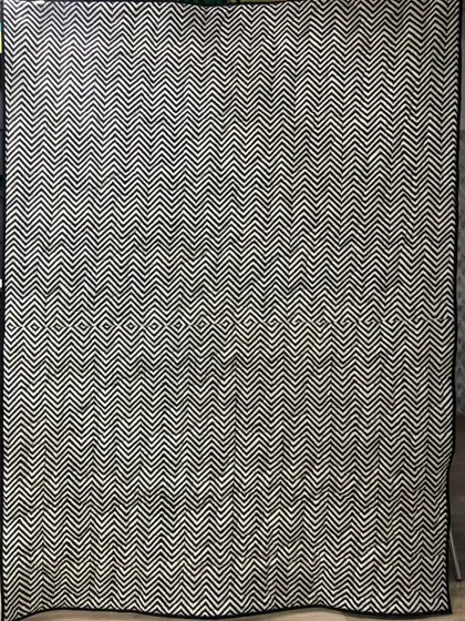The back of the checkerboard shirt quilt, featuring a bold black-and-white chevron pattern.