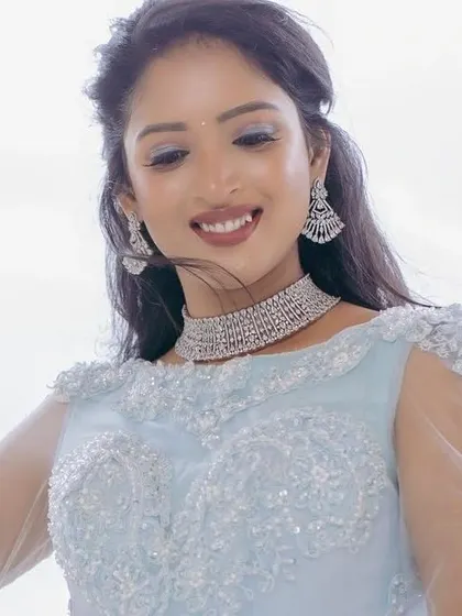 A model in a powder blue gown, styled with a simple and elegant diamond choker for a contemporary look.