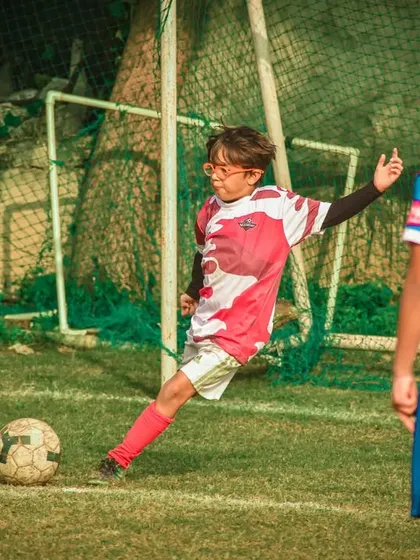 A player takes a penalty kick, a moment of high pressure and opportunity.