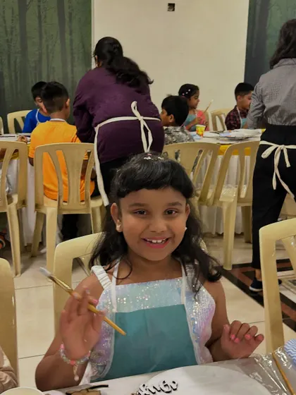 A happy artist at work. This girl's bright smile says it all. My workshops are designed for all skill levels, ensuring every child feels confident and has a wonderful time exploring their creativity.