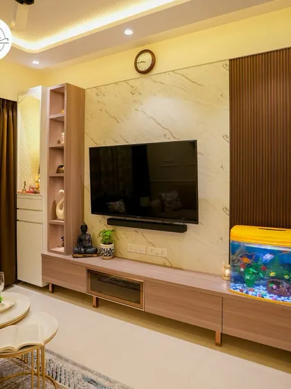 The entertainment center in this living room features a marble-finish back panel and a sleek, low-profile console with an aquarium.