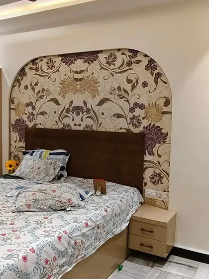 For this bedroom, I created a custom headboard effect by installing a floral wallpaper within an arched shape on the wall.