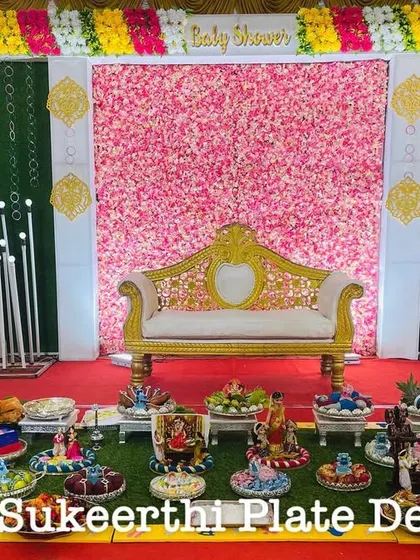 For this baby shower in Karamadai, I arranged 11 German silver plates on a grass floor. The silver adds a touch of elegance and contrasts beautifully with the colorful items.