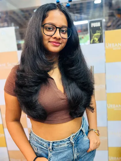This front-on view shows the face-framing layers and the overall healthy, bouncy look of the haircut.