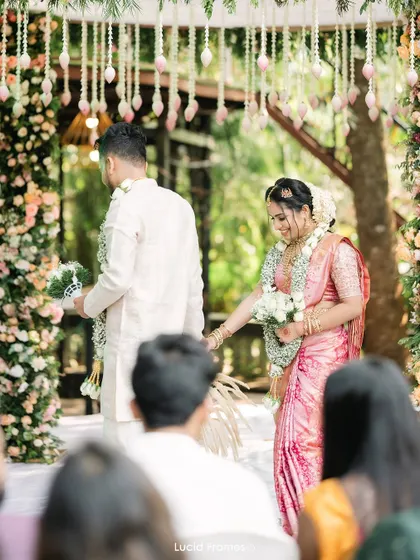The couple at the mandap, a shot from the guests' perspective that makes you feel like you are there.