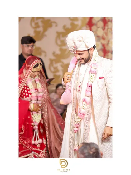 A candid moment during the wedding ceremony. The groom's gentle smile as he looks at his bride tells a story of love and happiness.