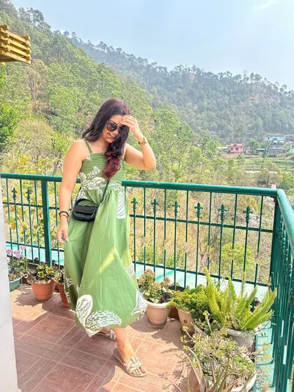 The wind catching my dress on the balcony. The print and color blend beautifully with the natural surroundings.