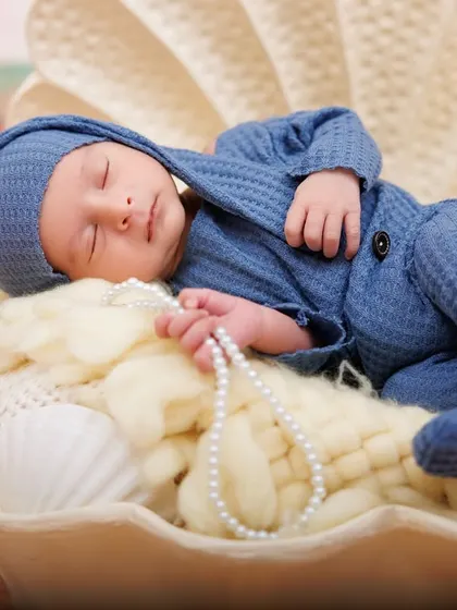 A precious pearl found in an oyster shell. This newborn is peacefully asleep in a shell prop, part of my creative beach and ocean themes.