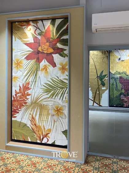 A closer look at two of my custom tile murals. On the left, a vibrant tropical flower design, and on the right, a serene scene with hummingbirds and a golden sun. These panels show the incredible detail and color I can achieve with custom printing.
