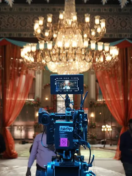 A behind-the-scenes shot from the movie 'Deva', showing the camera and the grand chandelier that was a key part of the set and lighting design.