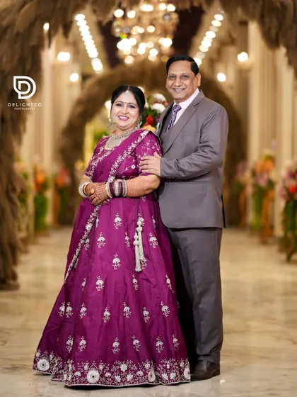 A classic portrait of the happy couple at their 25th anniversary party. Their smiles show a love that has deepened and grown stronger over the years.