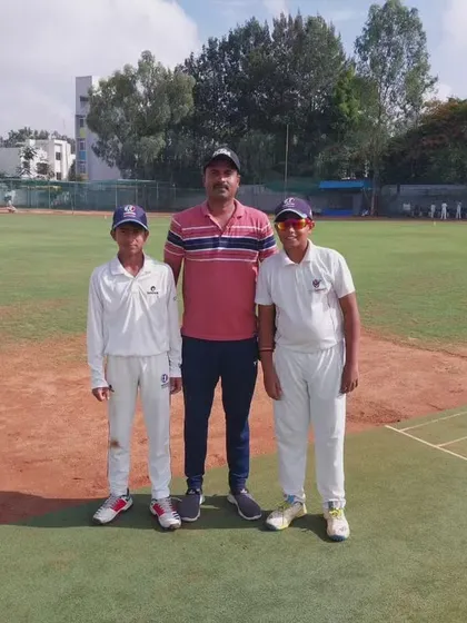 A group photo of a coach and two U-12 players, capturing the positive environment at our academy.