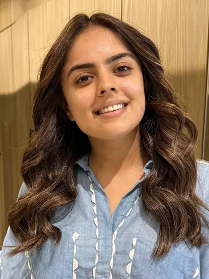 A classic highlight blend for a fresh, summer-ready look. The client's smile shows how happy she is with her new hair.