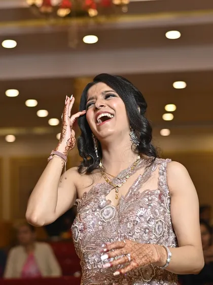 A moment of unrestrained laughter from the bride. Capturing these genuine expressions of happiness is what our candid photography is all about.