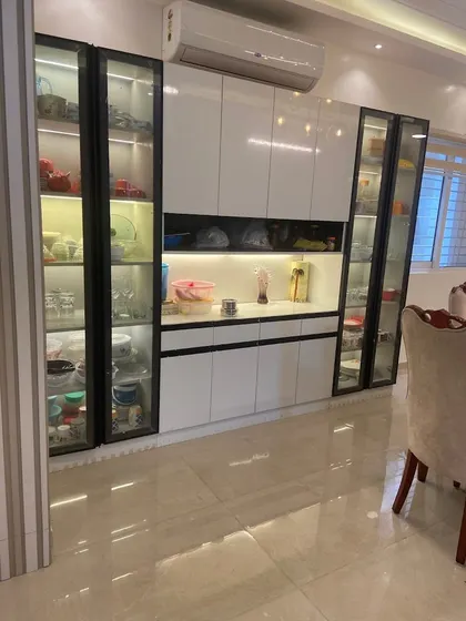 A custom crockery unit I designed for a dining area. It features glass-paneled doors with internal lighting to display fine china, along with closed cabinets for everyday dinnerware.