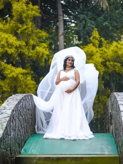 Another beautiful angle of the white maternity gown, with its trail catching the wind. This outfit is perfect for capturing angelic and graceful maternity portraits.