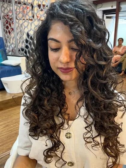 This cut for long curly hair focuses on maintaining length while adding shape.