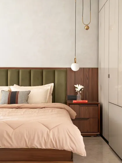 You don't always need bold colors to make an impact. This bedroom uses a neutral palette of beige, cream, olive green, and wood to create a calm and soothing atmosphere. The pendant light adds a touch of modern elegance.