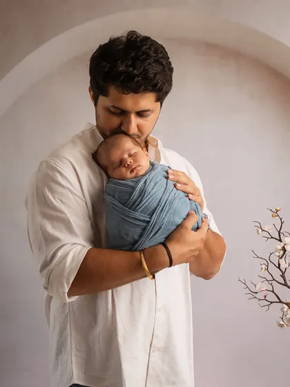 A father's gentle forehead kiss. This pose is a classic for a reason, showing tenderness and protection in one simple frame.