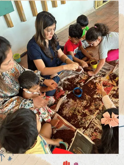 A closer look at our seed planting activity. I guide the children as they scoop and pour soil, which is excellent practice for their coordination and motor skills. It's a messy, hands-on lesson in biology.
