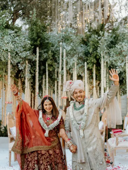 The happy couple waves to their guests after the ceremony. This image is full of positive energy and marks the official start of their new life together.