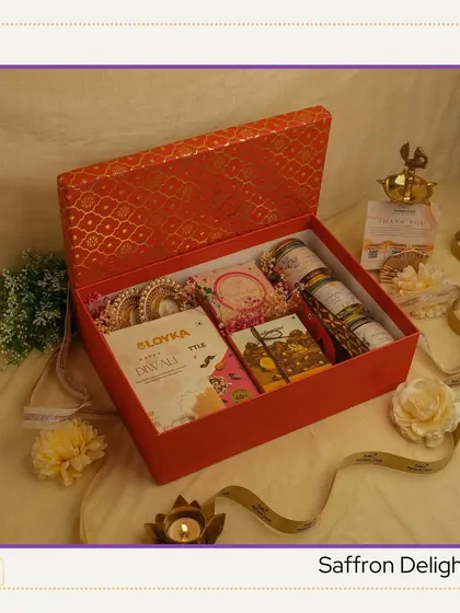 The "Saffron Delight" hamper comes in a vibrant orange box. It’s curated with a mix of traditional sweets and modern treats, perfect for celebrating the festival of lights.