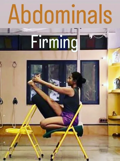 This is a variation of Navasana (Boat Pose) using two chairs for support. This setup helps to isolate and engage the abdominal muscles for firming and toning, while also working on hamstring flexibility and spinal length.