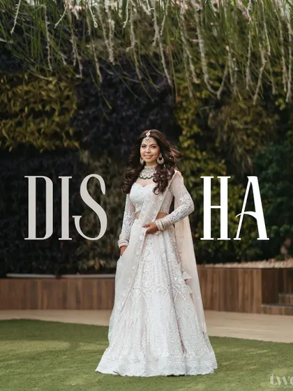 A beautiful portrait of the bride in her elegant off-white lehenga, with her name "DISHA" artistically placed. A modern and personalized take on the classic bridal shot.