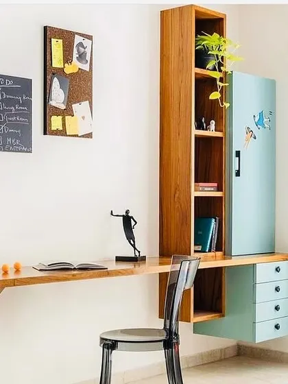 This simple yet charming study table design blends teal blue drawers with warm wooden tones. The floating design keeps the floor clear, and the open shelves provide ample storage for books and decor.