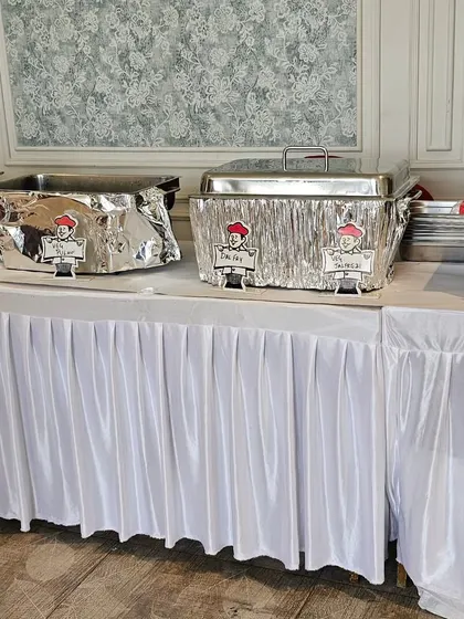 Our buffet setup for a birthday party, with chafing dishes neatly covered and labeled to keep the food hot and fresh for guests.