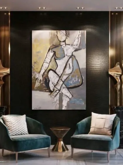A formal seating area that exudes opulence. The design features plush velvet armchairs, a textured black wall, abstract art, and sculptural elements on marble pedestals for a gallery-like feel.