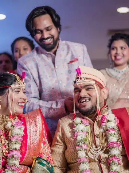 A candid moment of laughter shared between the couple and their family, capturing the genuine joy of the day.